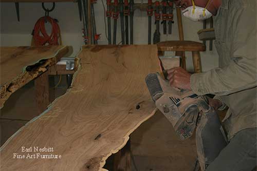 Earl sculpting edge of mesquite slabs for custom made live edge dining table